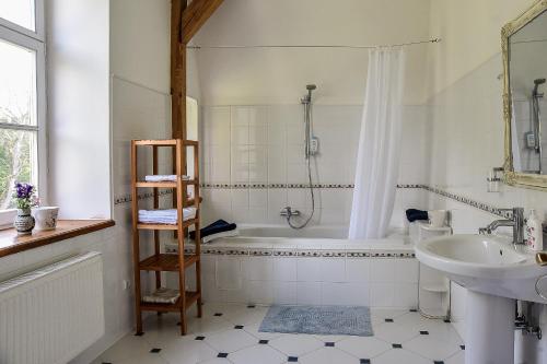 a bathroom with a bath tub and a sink at Maras Manor in Turlava