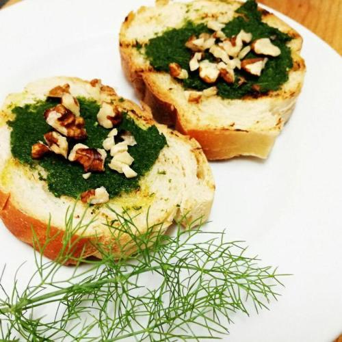 a white plate with a piece of bread with greens on it at Agriturismo Zì Carmine in Agerola