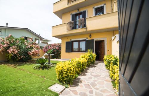 a house with a walkway in front of it at Hotel La Maison Jolie in Fiumicino
