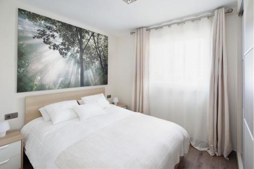 a bedroom with a white bed and a large window at Luxury Apartment In Marbella in Marbella