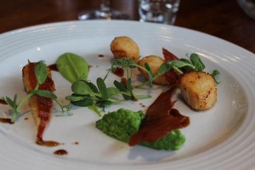 a white plate with food on a table at Blue Bell Country Inn in Knaresborough