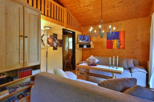 a living room with a couch and a table at Ferienhaus Mitterdorf in Philippsreut