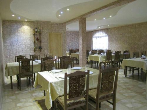 a restaurant with tables and chairs in a room at B&B Byurakan-Vanush in Byurakan