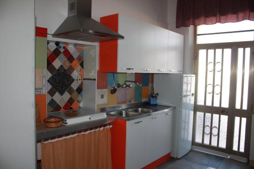 a small kitchen with a sink and a stove at Appartamento Prima Fila mare in Cupra Marittima