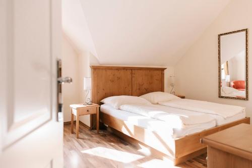 a bedroom with a large bed and a mirror at Gästehaus Annemaria in Retz