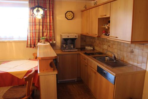 a small kitchen with a sink and a microwave at Haus Aster in Wagrain