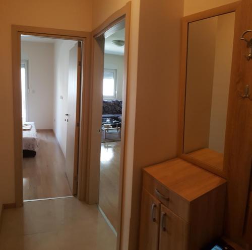 a room with a closet and a mirror and a hallway at Zebra in Podgorica