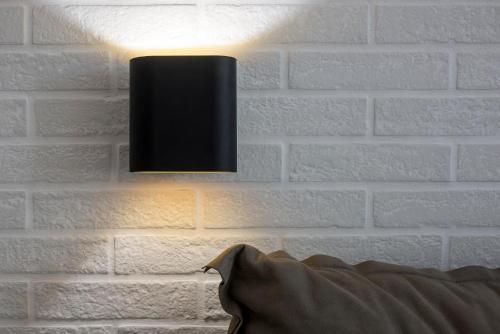 a black light on a white brick wall at The Secret Boutique Hotel in Lefkada