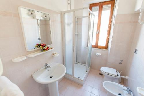 a bathroom with a sink and a shower and a toilet at Hotel International in Tortoreto Lido