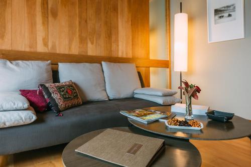 a living room with a couch and a table at Las Balsas Relais & Chateaux in Villa La Angostura