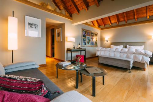 a living room with a couch and a bed at Las Balsas Relais & Chateaux in Villa La Angostura