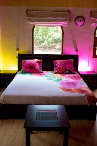 a bedroom with a large bed with a window at Le Chateau du Lac de Mantasoa in Mantasoa