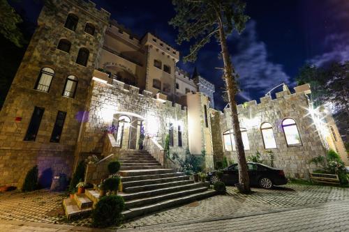a building with stairs and a car parked in front at Valentina Castle in Ognyanovo