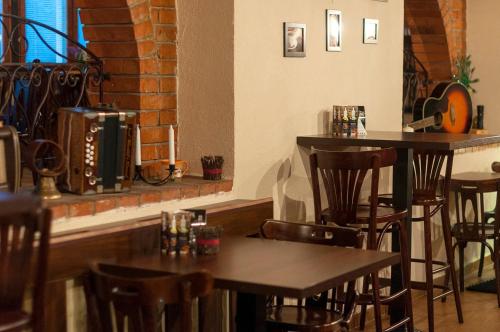 a bar with wooden chairs and tables in a restaurant at Penzión Wellness & Restaurant Zoborská, free parking in Nitra