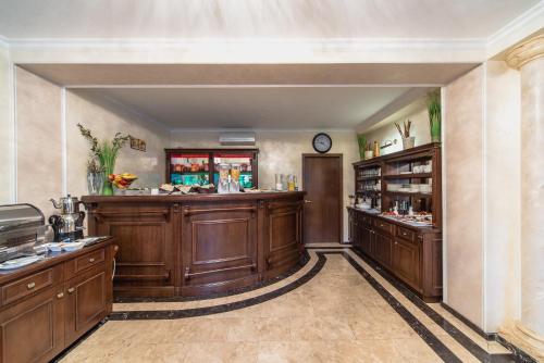 a large room with a bar with wooden cabinets at Boutique Hotel Boulevard in Yalta