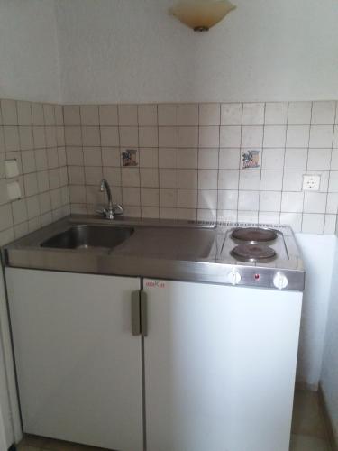 a kitchen with a sink and a stove at Apaggio Apartments in Katapola
