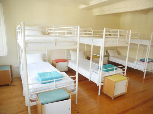 a room with two bunk beds and some boxes at Santiago 31 Hostel in Guimarães