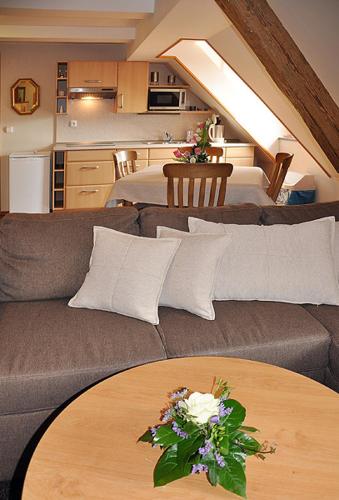 a living room with a couch and a table at Apartmány Rosalka in Stará Oleška