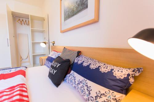 a bedroom with a bed with blue and white pillows at Accra Luxury Apartments in Accra