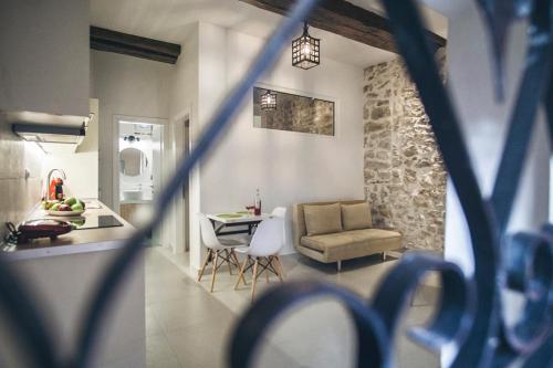 a kitchen and living room with a couch and a table at S&G Corfu Old Town Apartments in Corfu