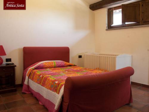 a bedroom with a bed and a couch in it at Agriturismo Antica Sosta in Viterbo