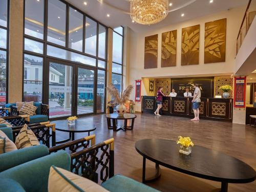 a lobby of a hotel with tables and chairs at Sapa Freesia Hotel in Sa Pa