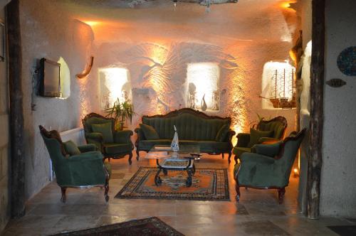 a living room with green couches and a table at Elite Cave Suites in Goreme