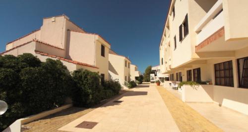 an empty sidewalk in front of a building at Hotel Priscapac Resort & Apartments in Prizba