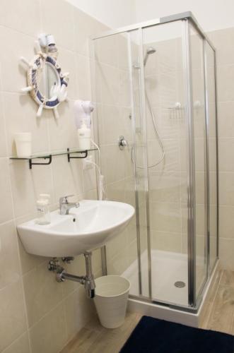 a bathroom with a sink and a shower at Villetta Sole in Bari Palese