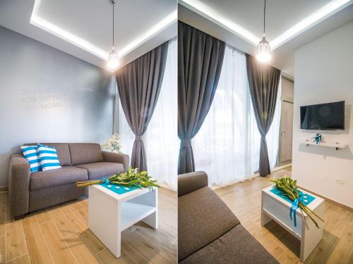 a living room with a couch and a table at IDRO Studio Apartments directly at the beach in Split
