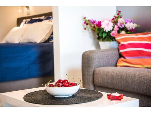 a bowl of cherries on a table in a living room at IDRO Studio Apartments directly at the beach in Split