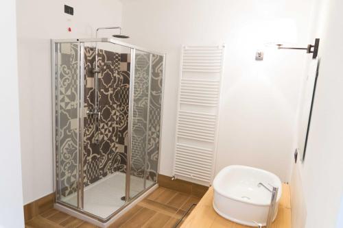 a bathroom with a glass shower and a toilet at Rocca d'Anfo B&B-Apartments Lake View in Rocca dʼAnfo