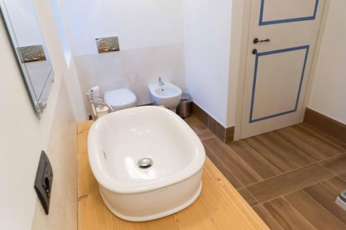 a bathroom with a toilet and a sink at Rocca d'Anfo B&B-Apartments Lake View in Rocca dʼAnfo