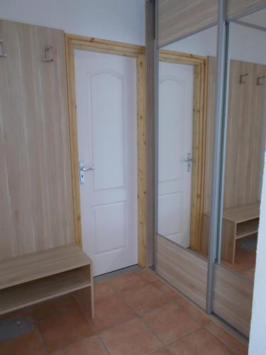 a room with two doors and mirrors in a room at Kristály Vendégház in Bogács