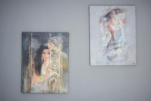 two paintings of a woman in a mirror on a wall at Seralis Pelion in Afissos
