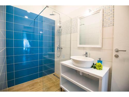 a bathroom with a sink and a glass shower at IDRO Studio Apartments directly at the beach in Split