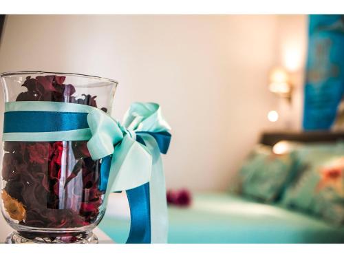 a glass vase with a bow on a table at IDRO Studio Apartments directly at the beach in Split