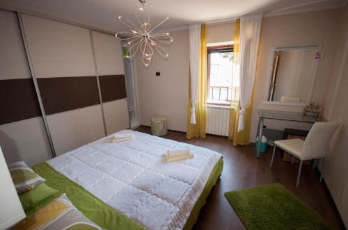 a bedroom with a large white bed and a window at Dario Room in Novigrad Istria