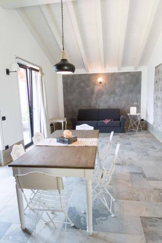 a dining table and chairs in a living room at Rocca d'Anfo B&B-Apartments Lake View in Rocca dʼAnfo