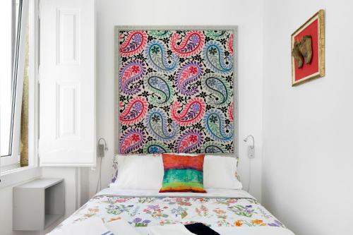 a bedroom with a bed with a colorful headboard at FeelingLisbon Tejo in Lisbon
