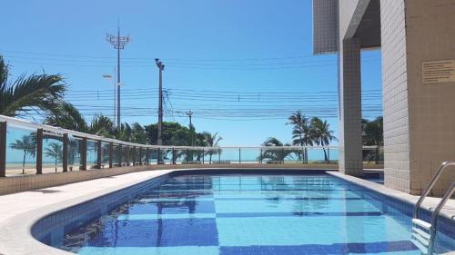 a swimming pool with a view of the ocean at Apart-Hotel Terraços do Atlântico in Fortaleza