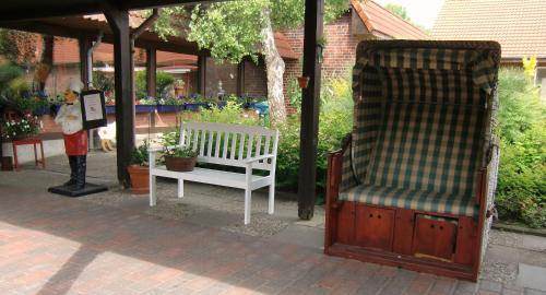 a white bench sitting under a gazebo at Landhaus Pfahlershof in Karolinenkoog