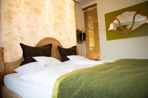 a bedroom with two beds with white sheets and a window at Hotel Heiligenstein in Baden-Baden