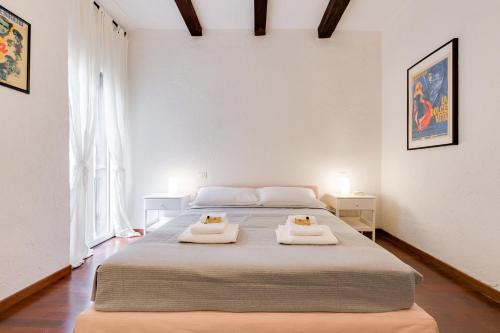 a bedroom with a large bed with two towels on it at Rome as you feel - Chiavari 38 Apartment in Rome