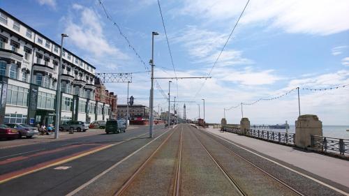 a street with cars parked on the side of the road at The President Hotel in Blackpool