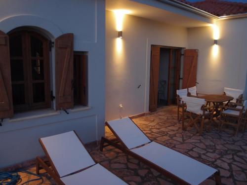 a room with a table and chairs and a dining room at Myrtos Bay Apartments in Anomeriá