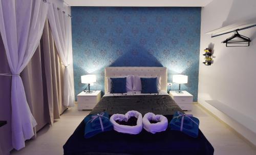 a bed in a room with a white bedspread at Maschio Angioino Suite - Bed and Breakfast Napoli in Naples