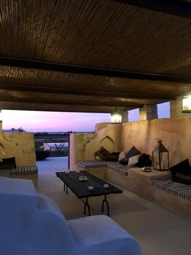 a living room with couches and a table in a room at Il Baglio sull'Acqua in Favignana