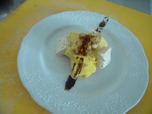 a piece of food on a white plate on a table at Albergo Dei Bersaglieri in Albaretto Della Torre 