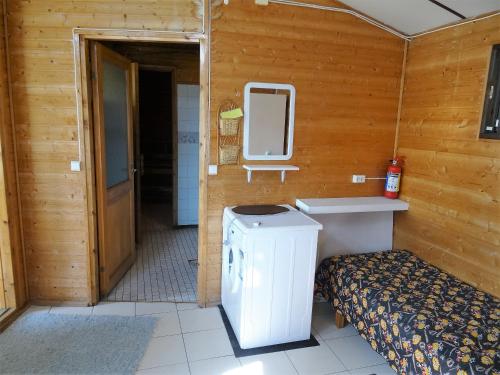 a bathroom with a toilet and a sink and a mirror at Lomakoivulehto in Saarijärvi